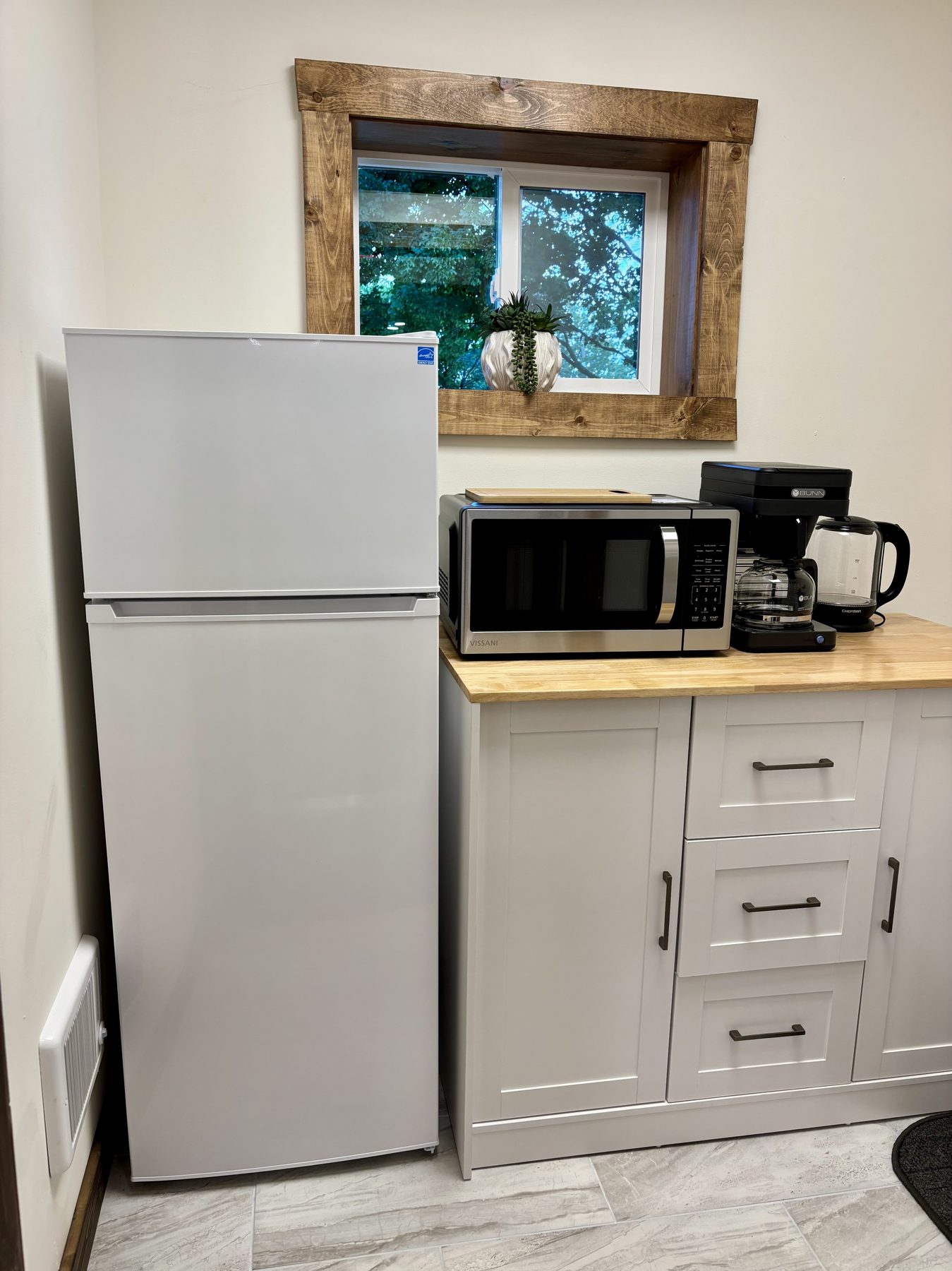 Kitchenette with refrigerator, microwave, and coffee maker
